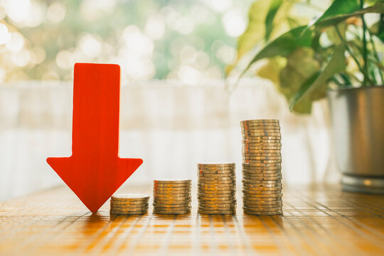 Down arrow with coin stack. Key concepts for success, methods, systems of raising or lowering Fed interest rates to correct inflation concepts.