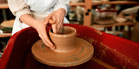 Fototapeta premium Hands, production and clay in workshop for creativity, art deco and development for startup. Pottery, artistic person and job or talent for small business, project or sculpture for retail in store