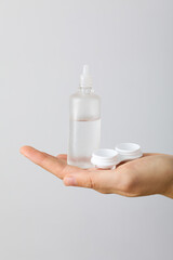 Contact lens liquid with lens container in hand