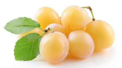 A bunch of yellow plums with a green leaf on top