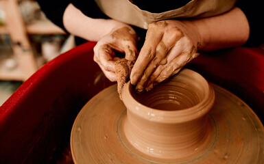 Hands, clay and pottery wheel with creativity for craft, tools and production at small business. Person, artist and entrepreneur with eco friendly material, sculpture and manufacturing in workshop