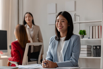 three businessperson are working in the modern office, group of employee has discussion about new project, working as teamwork is more effective, coworkers are brainstorming to planing great strategy