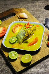 Ikan patin kuah kuning or catfish cooked in yellow sauce. Indonesian dishes have a savory and spicy taste