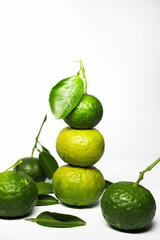 Stacked kaffir limes on a white background