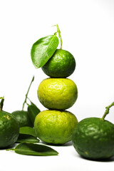 Stacked kaffir limes on a white background