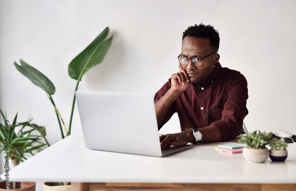 Poster thinking, black man and laptop at desk for research, email and communication or networking. business
