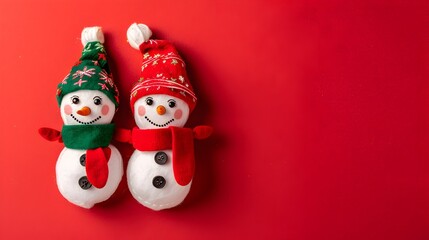 Fototapeta premium Jolly Snowman Elves Dressed for Festive Christmas on Plain Red Background