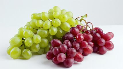 Fototapeta premium A bunch of green and red grapes cascading on a white surface, showcasing their freshness