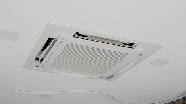 Ceiling mounted air conditioning cassette type unit with modern design and sleek appearance.
