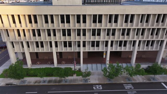 USA Federal Building. American flag with offices of government workers and various agencies. Aerial truck shot.