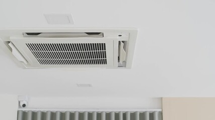 Ceiling mounted air conditioning cassette type unit with modern design and sleek appearance.