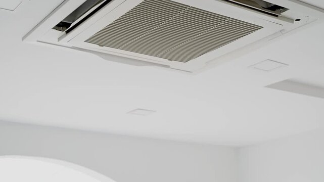 Ceiling mounted air conditioning cassette type unit with modern design and sleek appearance.