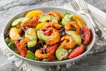 Citrus Shrimp and Avocado Salad closeup on the plate on the table. Horizontal