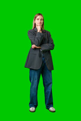 Young Woman Standing With Her Arms Crossed In Front Of A Green Screen