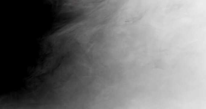 Smoke quickly moves from right to left side filling the screen and dissipates revealing black background. Smoke transition mask compositing element in 4k.