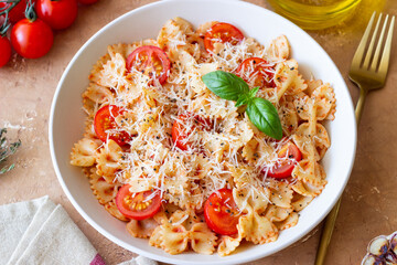 Farfalle pasta with tomatoes and cheese. Healthy eating. Vegetarian food.