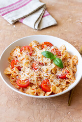 Farfalle pasta with tomatoes and cheese. Healthy eating. Vegetarian food.