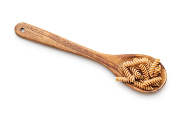 Uncooked whole grain pasta isolated on white background. Raw fusilli  in spoon.
