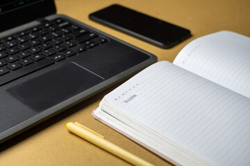 Office workplace with laptop, smart phone and notebook on wood table
