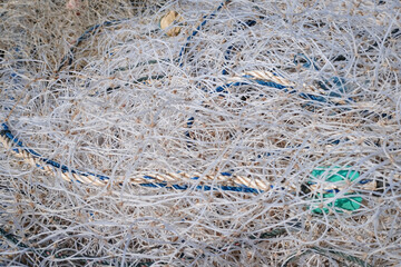 Macro close up of traditional fishing net and rope on small rowing boat
