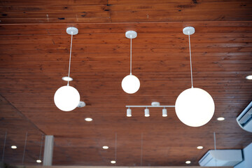 Light bulb hanging on wooden ceiling room