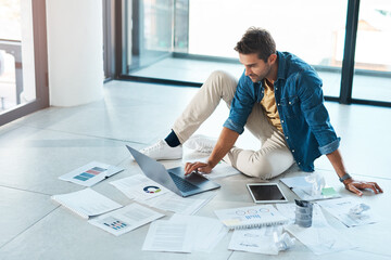 Man, documents and laptop on floor in office for research, information and brainstorming solution of financial growth. Male person, digital and paperwork with chart, data analysis and startup budget