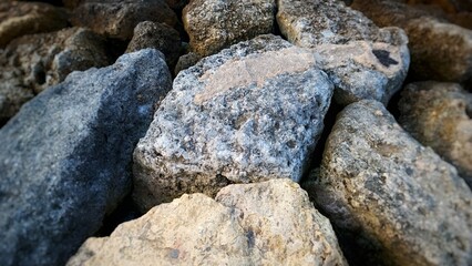 an arrangement of stones dividing the beach and sea to break the waves.