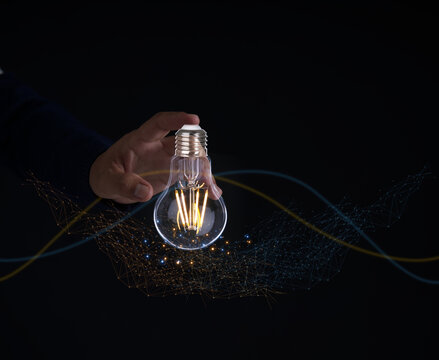 Solution or creative idea for designing a web banner or landing page for an innovative company with a hand sticking out of the screen with a light bulb. Famous abstract geometric shapes and lead lines