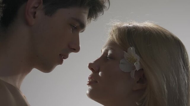 Young man and woman tender lovers faces shot, passion intimacy mood, candid feelings, attraction and desire. Love and affection relationships concept.