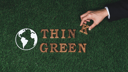 Hand arrange wooden alphabet in ecological awareness campaign with ECO icon design on biophilia...