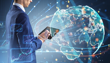 Close up of businessman hands using tablet with creative binary coding globe on blurry background. World map and global business technologies concept. Double exposure.
