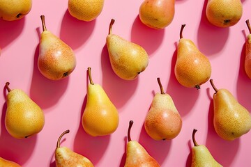 Colorful pattern of yellow pears on pastel pink color background. Ripe juicy whole pears. Autumn, fall, harvest festival. Minimal trendy repeated fruits. Sun shadow. Top view, flat lay. Natural food