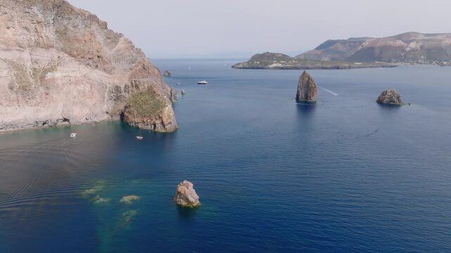 4K Aerial of Lipari and Vulcano, Aeolian Islands. Slowly tracking. Beautiful sunny day with Pietra Lunga in the foreground