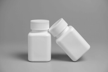 3D render of pill bottles on white base and placed on a grey background, Easy to use as mockup base for pill bottle label  mockup | HD redner