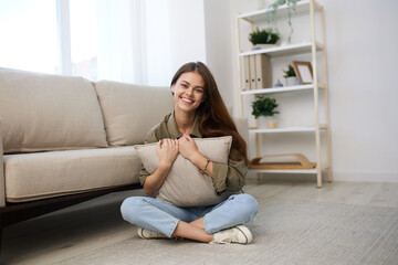 Obraz premium Happy Woman Relaxing on a Cosy Sofa in a Modern Apartment