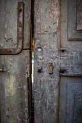 Close-up of a piece of a very old wooden door, historical architectural and design elements
