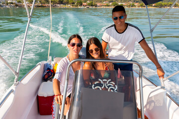 Three friends having fun on a sailing boat