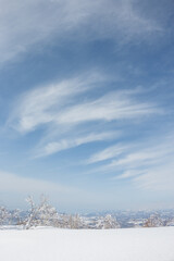 White clouds in winter sky above frozen snow landscape in Hokkaido Japan