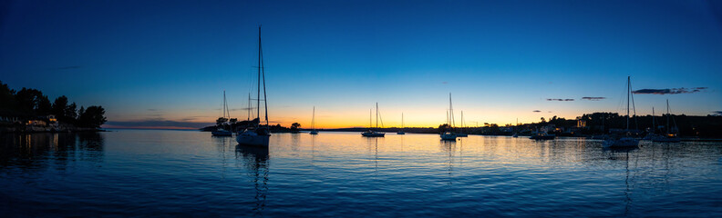Panorama view of Yachts moored on buoys near the shore in the bay of Uvala Gradina near the town of Vela Luka on the island of Korcula at night time in Croatia © dtatiana