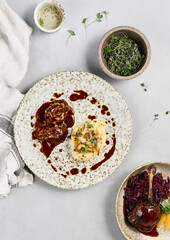 Delicious Beef Cheeks and Creamy Mashed Potatoes with Demi-Glace Sauce on Rustic Plate