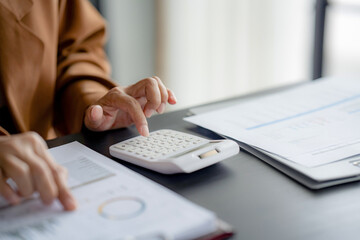 Businesswoman reading business information and working about calculating tax