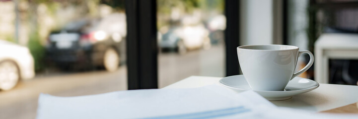 Business desk with coffee in contemporary office.