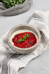 Panna Cotta with Berries in Rustic Bowl on Gray Tablecloth - Elegant Dessert