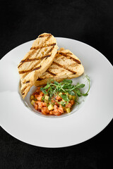 Salmon Tartare with Avocado and Ciabatta: Gourmet Dish on White Plate