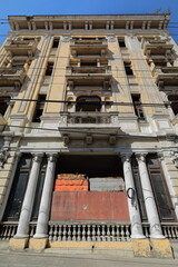 Boarded up entrance of abandoned building from the 1930s on Hartmann Street with a four-storey, balcony type Art-Deco facade. Santiago-Cuba-528