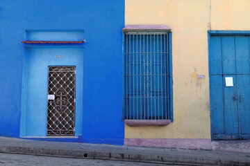 Peach-cream facade, azure blue wall-door-grille-shutter, brown wood door-white grille, refurbished...