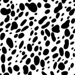 Fototapeta premium Classic black and white cow skin seamless vector pattern. Seamless pattern features a classic black and white dalmatian print.