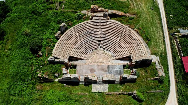 Top down aerial drone shot of the Theatre of Dodona in the Epirus region in Greece. Drone view over ancient historical greek amphitheater. Archaeological site.