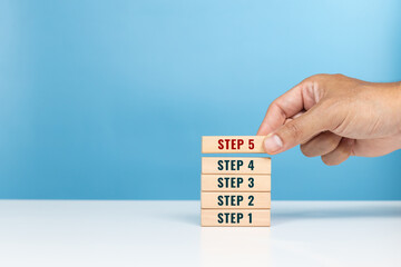 Step, begin, important start, method and step process concept. Hand arrange the wooden blocks of...