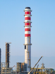 Hydrogen Refinery Under Construction with Prominent Chimney in the Foreground
